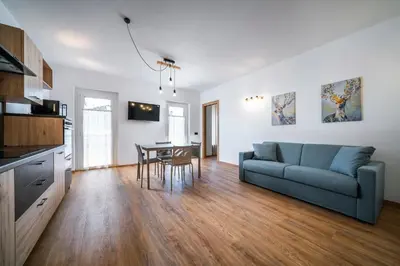 a living room with a couch and a table at Cauriol Suites 2.3 in Cavalese