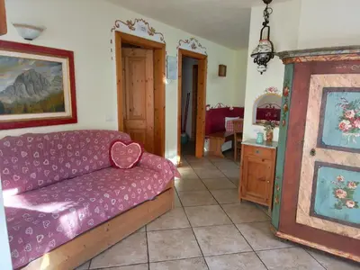a living room with a couch and a table at Apartments Cableway Canazei in Canazei