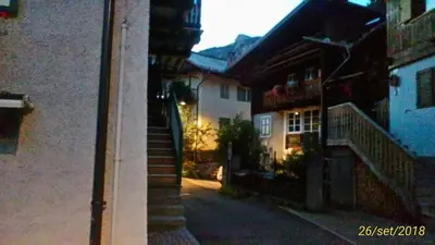 an alley with a stairway leading up to a building at Apartments Cableway Canazei in Canazei