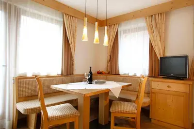 a hotel room with two beds and a mirror at Residence Angelica in Selva di Val Gardena