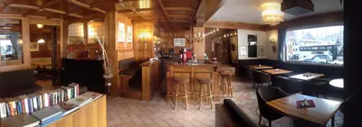 a restaurant with a bar and some tables and chairs at Park Hotel Mater Dei in Pozza di Fassa
