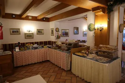 a room with a table with food on it at Park Hotel Mater Dei in Pozza di Fassa