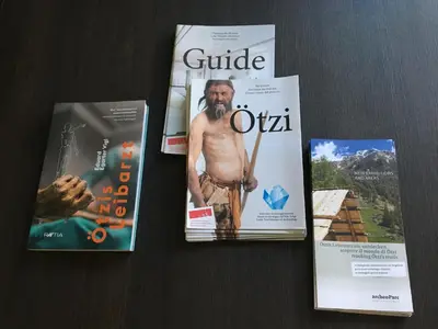 three magazines sitting on top of a table at Apartment Villa Huber in Bolzano