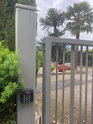 a gate with a solar panel next to a fence at Apartment Villa Huber in Bolzano