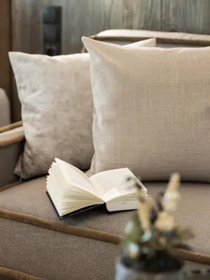 an open book sitting on top of a couch at Arieshof in Floronzo