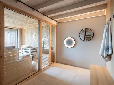 a room with a glass door and a mirror at Arieshof in Floronzo