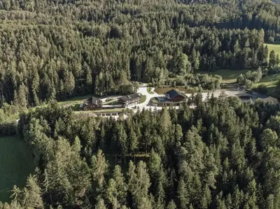 an aerial view of a resort in a forest at Arieshof in Floronzo