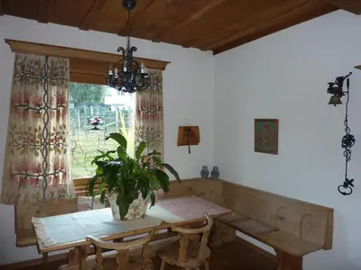a dining room with a table and a potted plant at Hotel Zima in Merano
