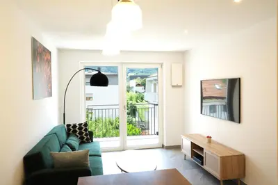 a living room with a couch and a table at Apartment Oleander - Alpstay in Naturno