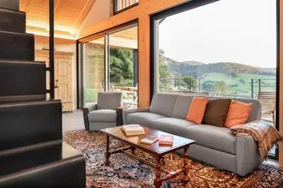 a living room with a couch and a table at Transmontana in Vols am Schlern