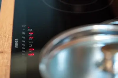 a close up of a stove top with a metal pot at Transmontana in Vols am Schlern