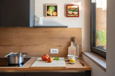 a kitchen counter with a cutting board and vegetables on it at Transmontana in Vols am Schlern