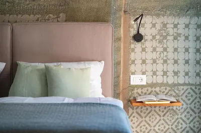 a bedroom with a bed and a table with a book at Transmontana in Vols am Schlern