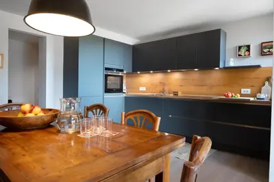 a kitchen with a wooden table with a bowl of fruit at Transmontana in Vols am Schlern