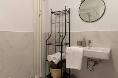 a bathroom with a sink and a mirror at Apartments Iris in Merano