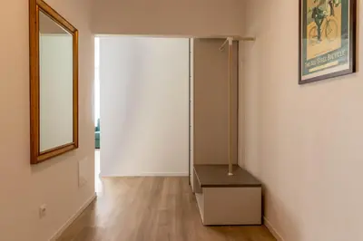 a room with a closet with a dresser and a mirror at Apartments Iris in Merano