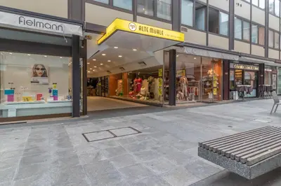 a store front with a bench in front of a building at Apartments Iris in Merano