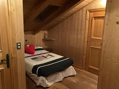 a small room with a bed in a cabin at Appartamento Cortina d'Ampezzo Lovely Hearts in Cortina dʼAmpezzo