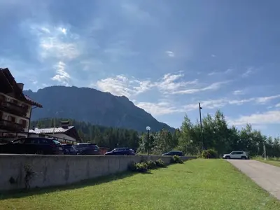 a parking lot with cars parked on the side of a road at Appartamento Cortina d'Ampezzo Lovely Hearts in Cortina dʼAmpezzo