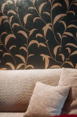 a wall with a black and white wallpaper and a pillow at Der Mittermoar in Bressanone