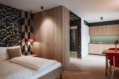 a bedroom with a bed and a dining room at Der Mittermoar in Bressanone