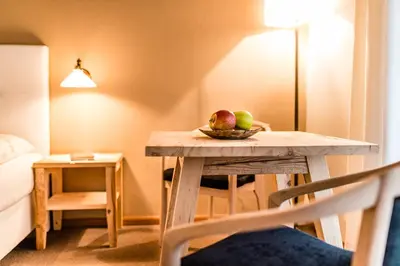 a table with a bowl of fruit on it in a room at Gasthof Eggwirt in Ultimo