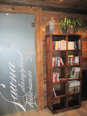 an open door to a book shelf with books at Gasthof Eggwirt in Ultimo