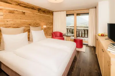 a hotel room with a bed and a television at Gasthof Eggwirt in Ultimo