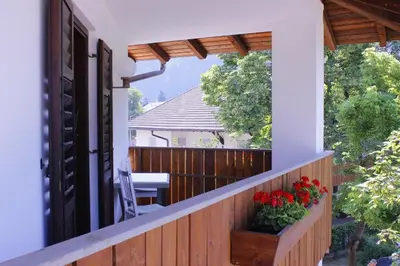 a balcony with a wooden fence and flowers on it at Zur Mühle in Ora/Auer