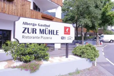 a sign for a zur mumpilla apartment building at Zur Mühle in Ora/Auer