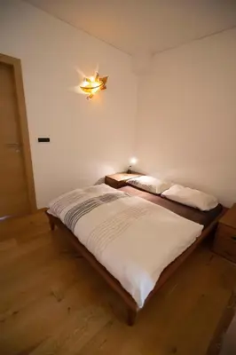 a bedroom with a bed with a light on the wall at Ka.La Apartment in Bolzano