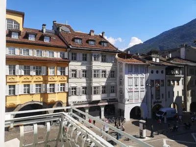 a group of buildings with mountains in the background at Ka.La Apartment in Bolzano