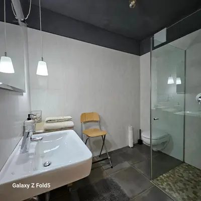 a bathroom with a sink and a shower and a toilet at Ka.La Apartment in Bolzano