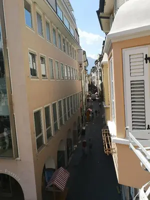 an alley between two buildings with people walking down it at Ka.La Apartment in Bolzano