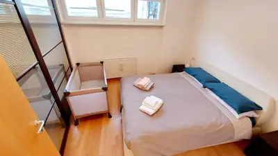 a bedroom with a bed with two towels on it at ROCCO's APARTMENT - in centro a Merano in Merano