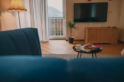 a living room with a blue couch and a table at 164 apt. in Val di Vizze