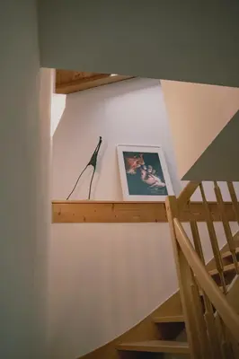 a staircase with a picture on the wall next to a stair case at 164 apt. in Val di Vizze