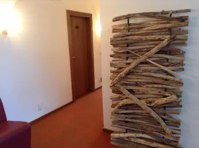 a stack of logs on the wall of a room at Hotel Daniela in Merano