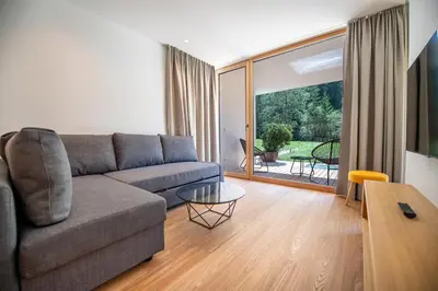 a living room with a couch and a table at Greva Apartments 1 in Santa Cristina in Val Gardena