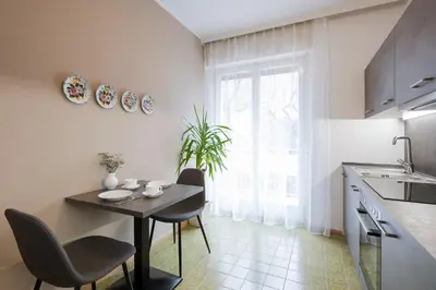 a white bathroom with a shower and a toilet at Villa Sabine in Merano