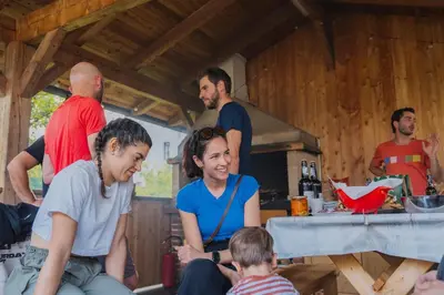 a group of people sitting around a table at Dolomitihouse ZIRMOL in Fiera di Primiero