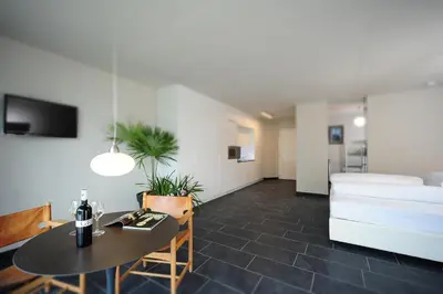 a living room with a table and a couch at Villa Sasso in Merano