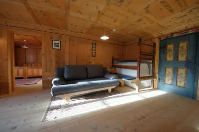 a living room with a couch and a bunk bed at Apartments Picenin in La Villa