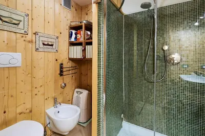 a bathroom with a shower and a toilet and a sink at Conte Moro, ospitalità in Vanoi in Canale San Bovo