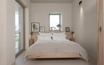 a bedroom with a large bed with white pillows at La Loggia Georg in Pianizza di Sopra