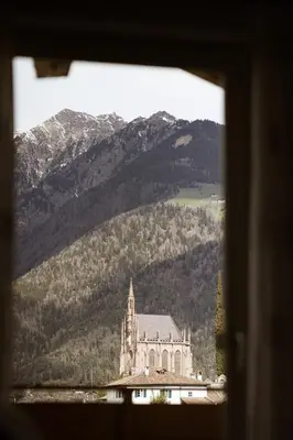 a view of a building with mountains in the background at Residence Walchhof in Schenna