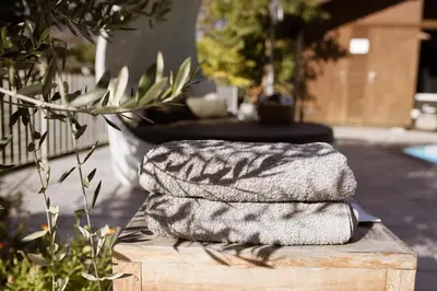 two towels sitting on top of a wooden table at Residence Walchhof in Schenna