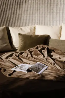 a book laying on top of a bed at Residence Walchhof in Schenna
