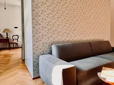 a living room with a couch and a wall at Haus Noldin - historische Herberge - dimora storica in Salorno sulla Strada del Vino