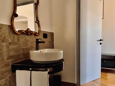 a bathroom with a sink and a mirror at Haus Noldin - historische Herberge - dimora storica in Salorno sulla Strada del Vino